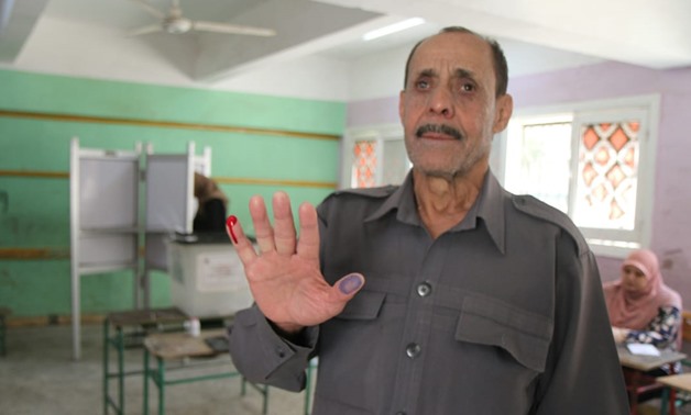 FILE - Visually-impaired man voting on constitutional amendments in 2019 - Egypt