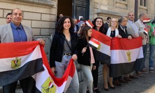 FILE - Egyptian expats standing in front of one of Egypt’s embassies after voting in the referendum on constitutional amendments 