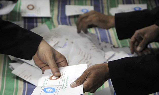 FILE - Officials count ballots after polls closed in Zagazig northeast of Cairo on Dec.15, 2012- Reuters