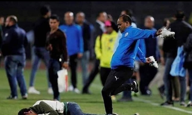 Zamalek’s staff member attacks one of the photographers after the match - FILE
