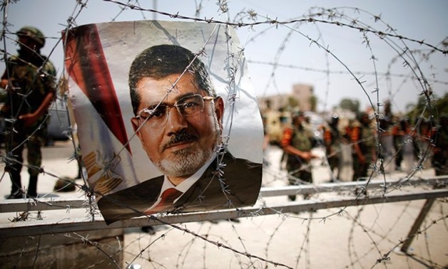 A portrait of deposed Egyptian President Mohamed Morsi is seen on barbed wire outside the Republican Guard headquarters in Cairo on July 6, 2013. (Reuters)