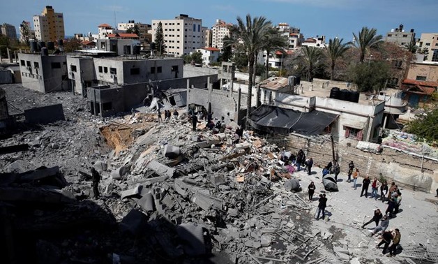 Palestinians inspect a destroyed Hamas site after it was targeted by an Israeli air strike in Gaza City March 26, 2019. REUTERS/Mohammed Salem