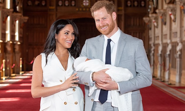 Britain's Prince Harry and Meghan, Duchess of Sussex are seen with their baby son, who was born on Monday morning, during a photocall in St George's Hall at Windsor Castle, in Berkshire, Britain May 8, 2019. Dominic Lipinski/Pool via REUTERS
