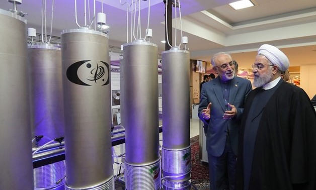 Made available on April 9, 2019 by the Iranian presidential office, this image shows Iranian President Hassan Rouhani (2nd L) as he listens to head of Iran’s nuclear technology organization Ali Akbar Salehi (R) (Iranian Presidency / AFP)

