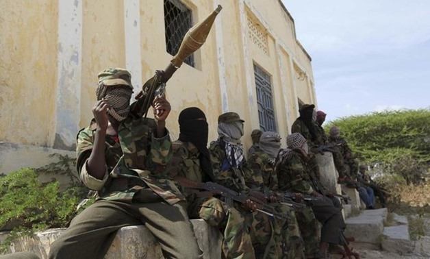 Al Shabaab soldiers sit outside a building during patrol along the streets of Dayniile district in Southern Mogadishu. (File/Reuters)
