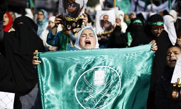 A girl carries a flag of the Muslim Brotherhood as she joins protesters from the Islamic Action Front during demonstration to show their solidarity with Palestinians and anger at a recent political arrest, after the Friday prayer in Amman November 28, 201