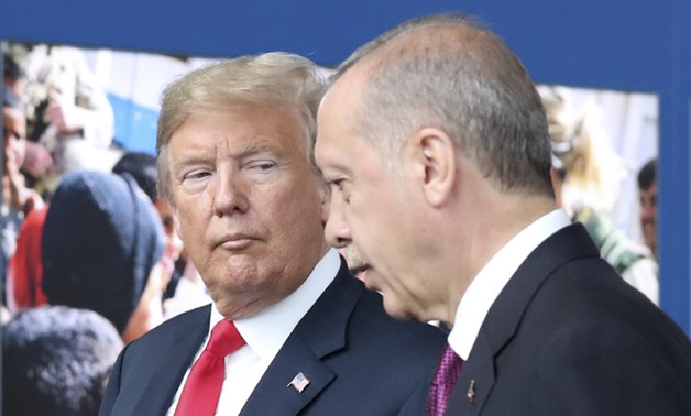 President Trump speaks with Turkish President Recep Tayyip Erdogan during a tour of the new NATO headquarters in Brussels - (Tatyana Zenkovich/AP)