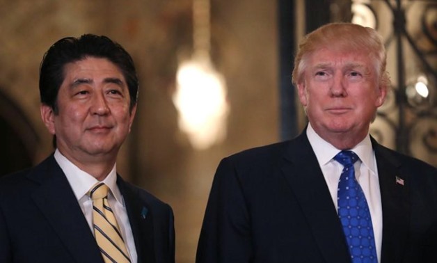 FILE PHOTO: Japanese Prime Minister Shinzo Abe and U.S. President Donald Trump pose for a photograph before attending dinner at Mar-a-Lago Club in Palm
