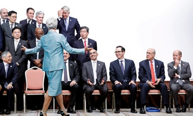 Christine Lagarde, managing director of the International Monetary Fund (IMF), gestures in front of Bank of Japan Governor Haruhiko Kuroda, U.S. Secretary of Treasury Steven Mnuchin, OECD's Secretary General Jose Angel Gurria Trevino, German Finance Minis