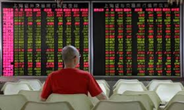 FILE PHOTO: An investor watches stock prices at a brokerage office in Beijing, China July 6, 2018. REUTERS/Jason Lee
