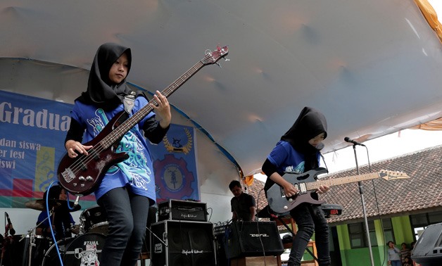 Widi Rahmawati (L) and Firdda Kurnia, members of the metal Hijab band Voice of Baceprot- REUTERS -Yuddy Cahya