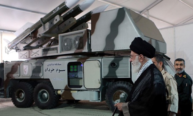 Iran's Supreme Leader Ayatollah Ali Khamenei is seen near a "3 Khordad" system which is said to had been used to shoot down a U.S. military drone, according to news agency Fars, in this undated handout picture. Fars news/Handout via REUTERS
