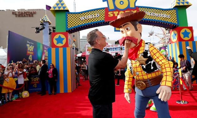 FILE PHOTO: Actor Tom Hanks poses with his character Woody at the premiere for "Toy Story 4" in Los Angeles, California, U.S., June 11, 2019. REUTERS/Mario Anzuoni/File Photo.
