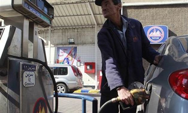 A worker pumps fuel at a petrol station in Cairo January 16, 2011. REUTERS/AsmaaWaguih