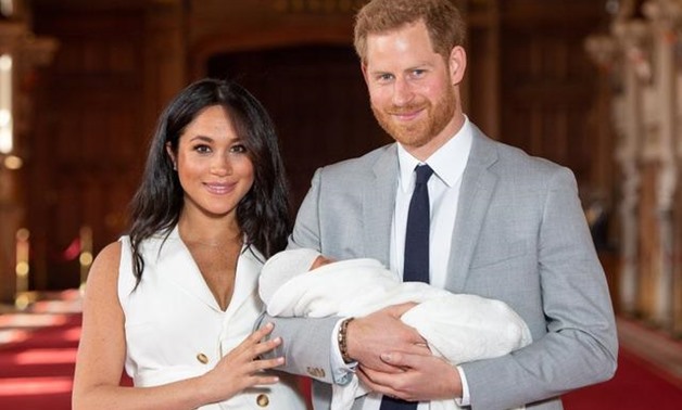 FILE PHOTO: Britain's Prince Harry and Meghan, Duchess of Sussex hold their baby son, who was born on Monday morning, during a photocall in St George's Hall at Windsor Castle, in Berkshire, Britain May 8, 2019. Dominic Lipinski/Pool via REUTERS
