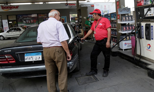 A worker fills a car at a Total petrol station in Cairo, Egypt, July 4, 2019. REUTERS/Hayam Adel
