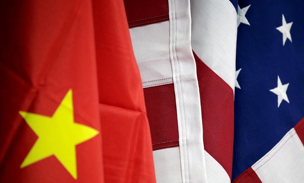 FILE PHOTO: Flags of U.S. and China are displayed at American International Chamber of Commerce (AICC)'s booth during China International Fair for Trade in Services in Beijing, China, May 28, 2019. REUTERS/Jason Lee/File Photo 
