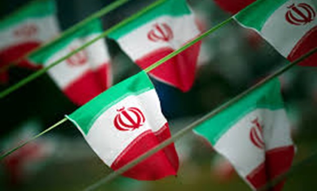FILE PHOTO: Iran's national flags are seen on a square in Tehran February 10, 2012. REUTERS/Morteza Nikoubazl/File Photo
