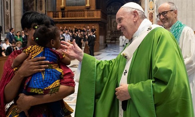 Pope Francis blesses a child after celebrating a Mass for migrants on the sixth anniversary of his trip to the island of Lampedusa, in the Vatican July 8, 2019. Vatican Media/­Handout via REUTERS

