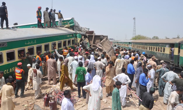Residents and rescue workers gather near the site after a passenger train collided with a cargo train in Sadiqabad, Pakistan July 11, 2019. REUTERS/Stringer NO RESALES. NO ARCHIVES.
