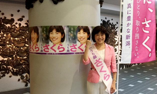 Sakura Uchikoshi, an opposition candidate for Japan's upcoming July 21 upper house election, poses in front of election posters in Mitsuke, Niigata, Japan, July 9, 2019. REUTERS/Linda Sieg
