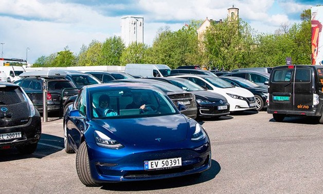 A man drives his electric car from Tesla Motors as he leaves an all-electric cars parking lot in Oslo on May 3, 2019. (AFP)
