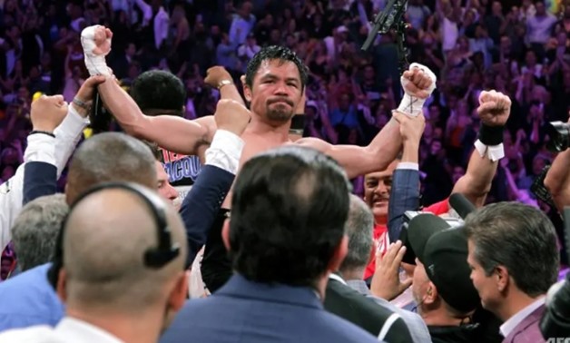 Filipino boxer Manny Pacquiao celebrates after beating US boxer Keith Thurman during their WBA super world welterweight title fight
