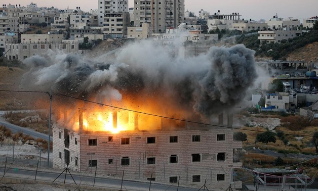 A Palestinian building is blown up by Israeli forces in the village of Sur Baher which sits on either side of the Israeli barrier in East Jerusalem and the Israeli-occupied West Bank July 22, 2019. REUTERS/Mussa Qawasma