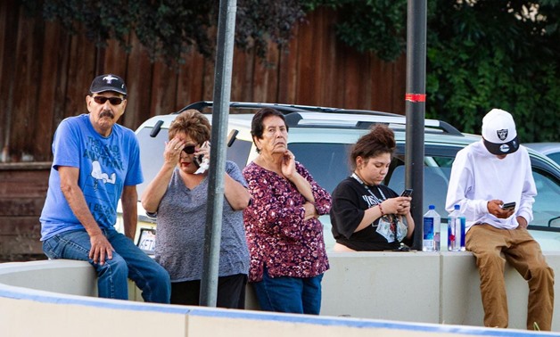 People look on from near the scene of a mass shooting during the Gilroy Garlic Festival in Gilroy, California, U.S. July 28, 2019. REUTERS/Chris Smead.
