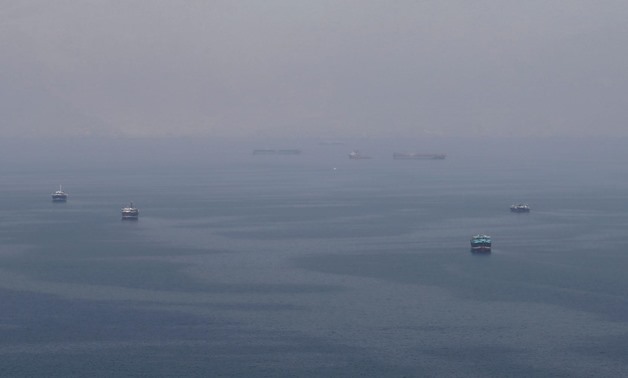 FILE PHOTO: Traditional Omani boats known as dhows, and cargo ships are seen sailing towards the Strait of Hormuz, off the coast of Musandam province, Oman, July 21, 2018. Picture taken July 21, 2018. REUTERS/Hamad I Mohammed/File Photo
