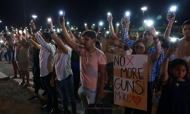 Mourners take part in a vigil near the border fence between Mexico and the U.S after a mass shooting at a Walmart store in El Paso U.S. in Ciudad Juarez. August 3, 2019. REUTERS/Carlos Sanchez
