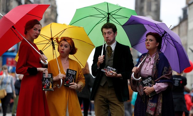 Performers hand out flyers on the The Royal Mile trying to attract people to their show, in Edinburgh, Scotland, Britain August 1, 2019. REUTERS/Russell Cheyne
