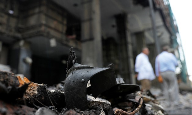 Belongings of victims are seen amid rubble in front of the damaged facade of the National Cancer Institute after an overnight fire from a blast, in Cairo, Egypt August 5, 2019. REUTERS/Amr Abdallah Dalsh