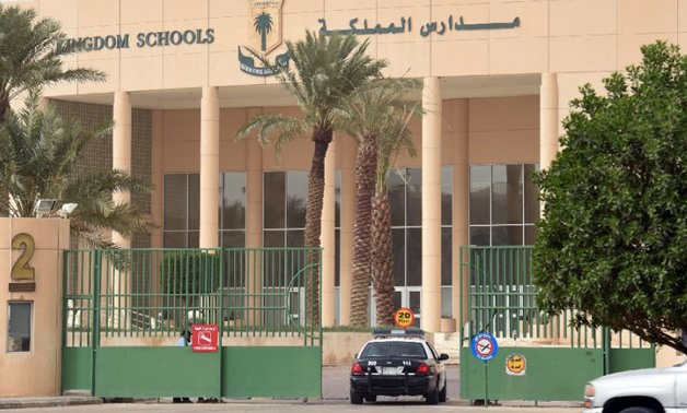 A police car passes through the main entrance of the Kingdom School in Riyadh on May 31, 2017 - AFP 