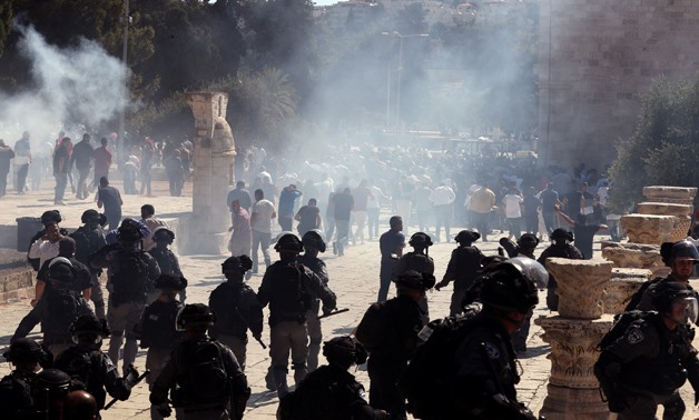 Smoke is seen after sound grenades exploded as Israeli police clash with Palestinian worshippers on the compound known to Muslims as Noble Sanctuary and to Jews as Temple Mount as Muslims mark Eid al-Adha in Jerusalem's Old City August 11, 2019. REUTERS/A