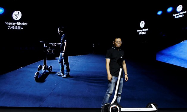 Ninebot President Wang Ye unveils semi-autonomous scooter KickScooter T60 that can return itself to charging stations without a driver, at a Segway-Ninebot product launch event in Beijing, China August 16, 2019. REUTERS/Florence Lo
