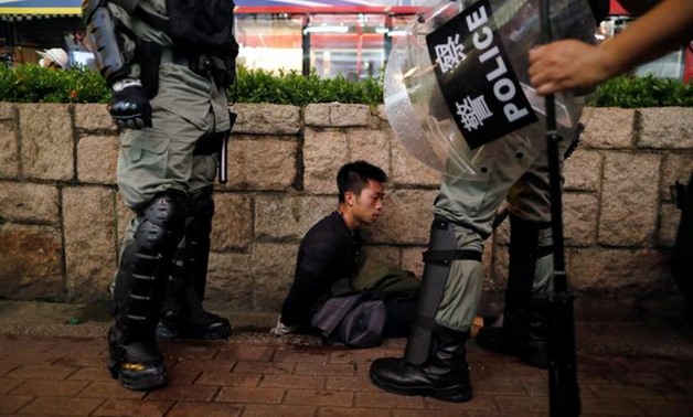 Riot police officers detain an anti-extradition bill protester during a demonstration in Tsim Sha Tsui neighbourhood in Hong Kong, China, August 11, 2019. REUTERS/Issei Kato
