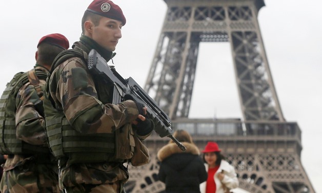 French soldier patrol near the Eiffel Tower in Paris as part of the highest level of “Vigipirate” security plan after a shooting at the Paris offices of Charlie Hebdo January 9, 2015. REUTERS/Gonzalo Fuentes