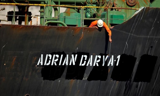 A crew member takes pictures with a mobile phone on Iranian oil tanker Adrian Darya 1, previously named Grace 1, sits anchored after the Supreme Court of the British territory lifted its detention order, in the Strait of Gibraltar, Spain, August. (Reuters