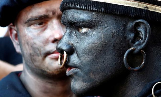 "The Savage", a white performer in a blackface disguise, takes part in the festival Ducasse d'Ath, in the western town of Ath, Belgium August 25, 2019. REUTERS/Francois Lenoir
