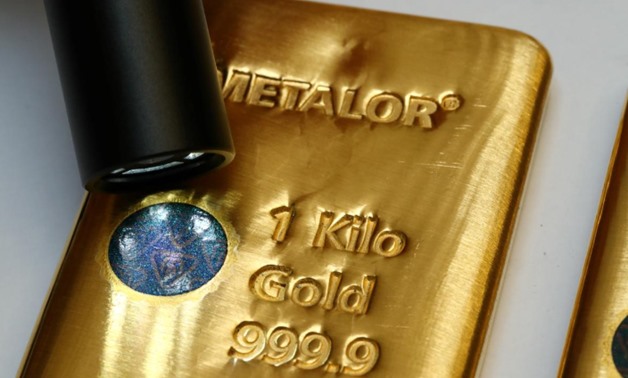 FILE PHOTO: The Sicpa Oasis validator system (bullion protect) is pictured on one kilogram bar of gold at Swiss refiner Metalor in Marin near Neuchatel, Switzerland July 5, 2019. REUTERS/Denis Balibouse
