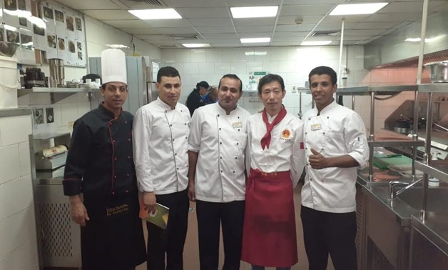 Chinese chef Hu Zhixia with Egyptian staff at a Hurghada hotel
