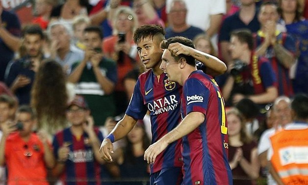 Caption: Barcelona's Lionel Messi (R) celebrates his goal with teammate Neymar against Mexican club Leon during their Joan Gamper Trophy match at Nou Camp stadium in Barcelona August 18, 2014. REUTERS/Gustau Nacarino 