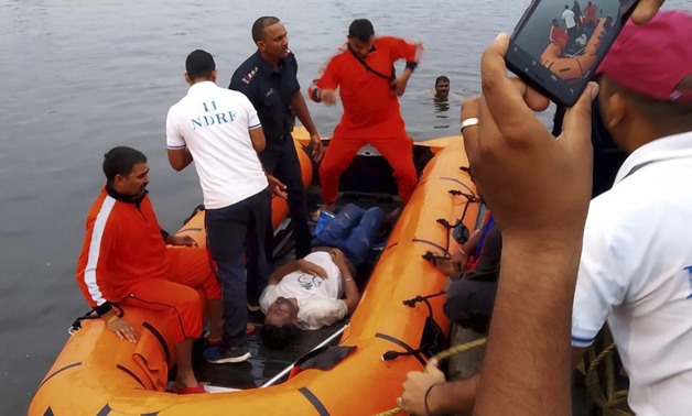 In this handout photo provided by the National Disaster Response Force, rescuers recover the body of a victim from a lake in Bhopal, in the central Indian state for Madhya Pradesh, Friday, Sept. 13, 2019. Police officer Akhil Patel said more than 10 Hindu