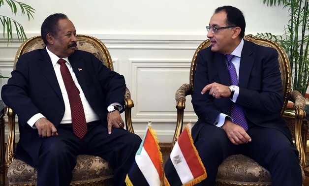 Sudanese Prime Minister Abdalla Hamdok meets with Egyptian Prime Minister Mostafa Madbouli (R) - Press photo