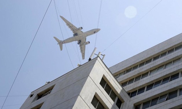Above, an Etihad Airways aircraft crosses at low altitude above buildings in the Lebanese capital Beirut’s coastal neighborhood of Hamra on July 10, 2019. (AFP)
