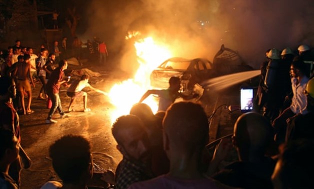 Civilians try to extinguish a fire from the blast outside the hospital. Shokry Hussein/Reuters