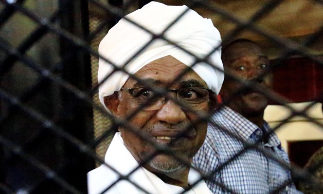 Sudan's former president Omar Hassan al-Bashir smiles as he is seen inside a cage at the courthouse where he is facing corruption charges, in Khartoum, Sudan August 31, 2019. REUTERS/Mohamed Nureldin Abdallah
