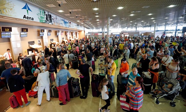 Thomas Cook passengers queue in front of check-in desks on the second day of repatriations at Reus airport, next to Tarragona, Spain, September 24, 2019. REUTERS/Albert Gea
