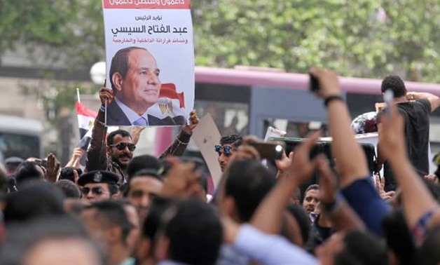 FILE - Protesters hold poster of Egyptian President Abdel Fattah al-Sisi in front of the Syndicate of Journalists, in Cairo, Egypt May 4, 2016 - Reuters